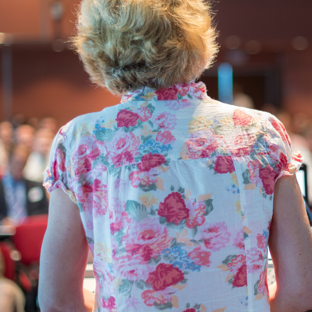 A person stands before a large auditorium