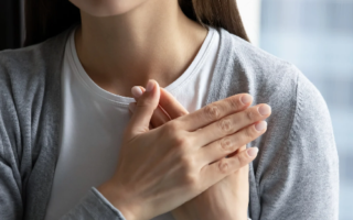 A woman with her hands over her heart