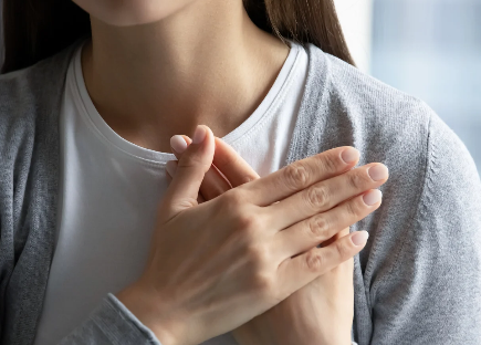 A woman with her hands over her heart