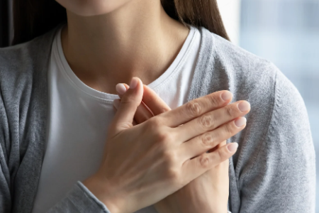 A woman with her hands over her heart