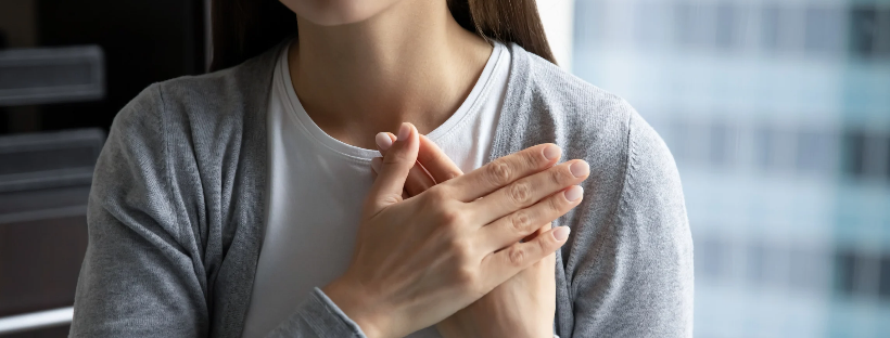 A woman with her hands over her heart