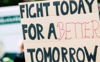 a sign reads: "fight today for a better tomorrow"