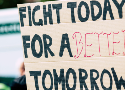 a sign reads: "fight today for a better tomorrow"