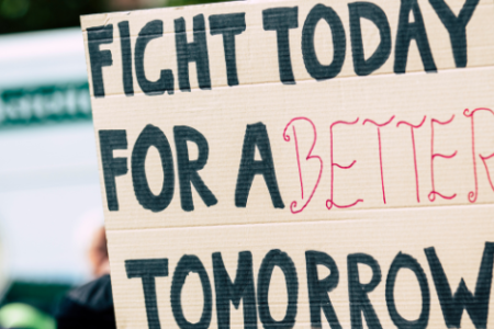 a sign reads: "fight today for a better tomorrow"
