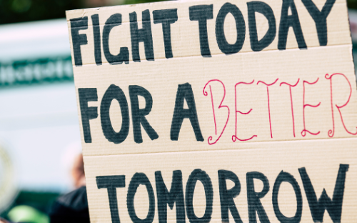 a sign reads: "fight today for a better tomorrow"