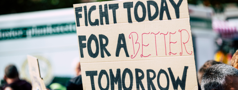 a sign reads: "fight today for a better tomorrow"