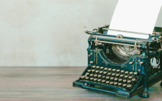 An old style typewriter sits on a table